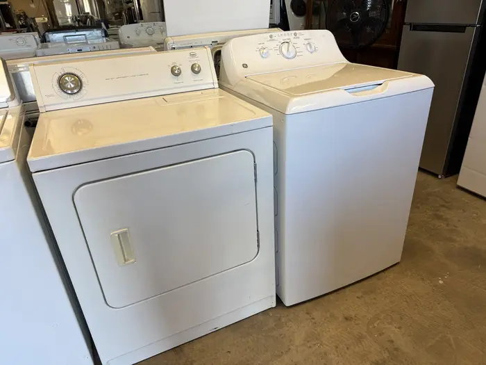 A white dryer and top-load washer side by side at RDM
